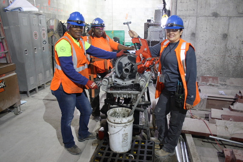 Journeywomen Nuelin Thompson, Tamara Lamond (Forewoman) and Rosalinda Nevarez of Five Star Electric pose in front of a conduit bender on the job at the MTA's East Side Access Project.